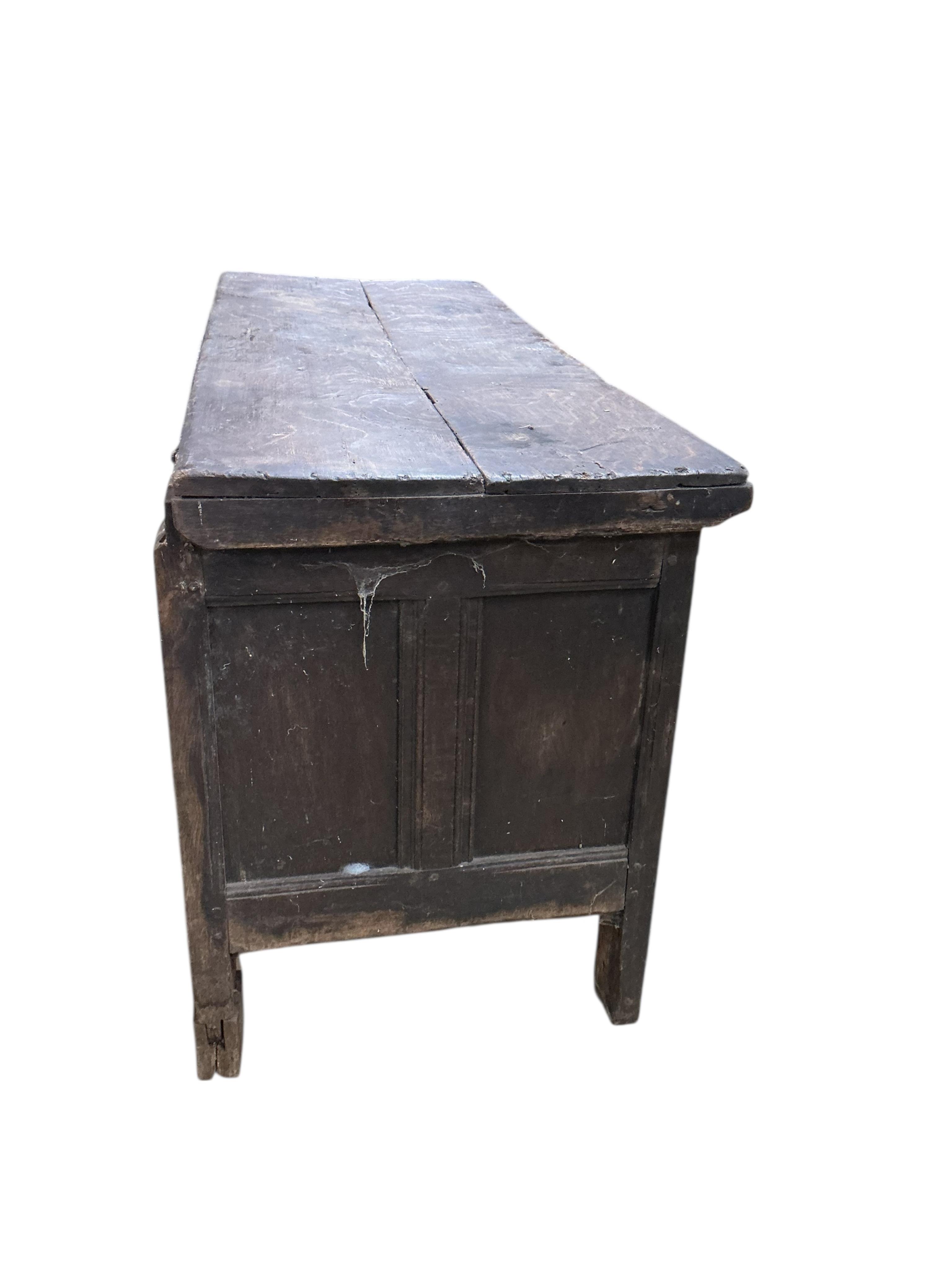 An 18th century panelled oak coffer, width 144cm, depth 54cm, height 72cm